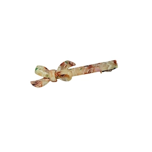 Elegant acetate bow hair clip with tortoiseshell pattern on a clean white background