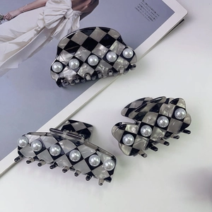 Three-piece hair claw set with grey checkerboard pattern and elegant white pearls