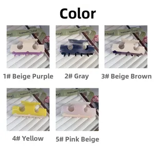 Macro shot showing five colorful acetate hair claws in various elegant shades for women