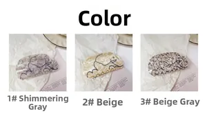 Vue détaillée de trois pinces à cheveux éléphant en acétate marbré gris, beige et gris