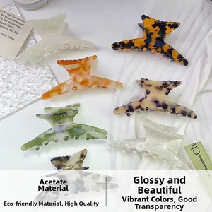 Detail of eco-friendly acetate fishtail hair claws in marble and amber textures