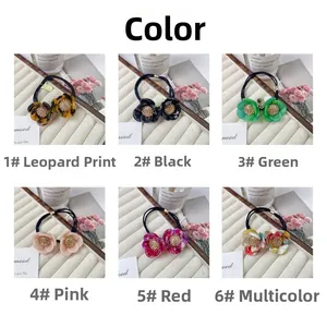 Close-up of double-layer flower hair ties in six colors with sparkling diamond centers