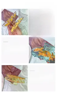 Detail view of transparent acetate goldfish claw clip showing internal 3D orange fish detail
