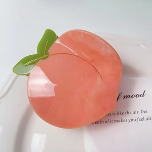 Pince à cheveux pêche en acétate rose avec feuilles vertes et texture marbrée pour femmes