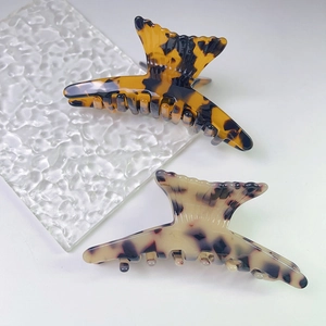 Elegant fishtail acetate hair claw clips with tortoiseshell and spotted patterns
