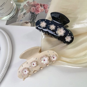 Elegant floral rhinestone hair claw clips in black and beige with acetate finish