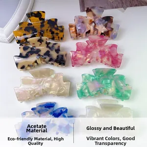 Close-up of assorted acetate claw clips in marble and tortoiseshell patterns