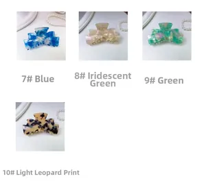 Detail view of acetate claw clips in four marble patterns with decorative pearls