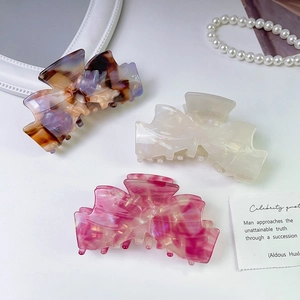 Elegant acetate bow hair claws in tortoiseshell purple, pearl white and marble pink