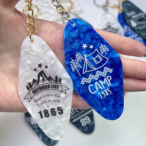 Vintage hotel style acrylic keychains with marble patterns and outdoor camp design