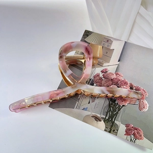 Detail of 13.5cm large pink marble acetate hair claw clip with strong metal spring