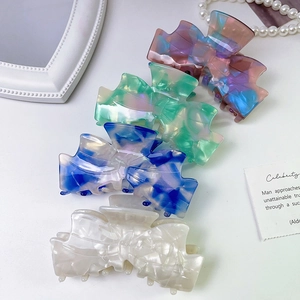 Colorful acetate bow hair claws set in pink, blue, green and cream with marble finish