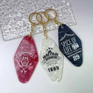 Three vintage acrylic diamond hotel keytags in burgundy pearl white and navy marble finish