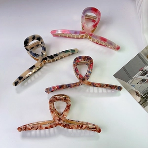 Set of four 13.5cm oversized hair claw clips in tortoise and floral acetate patterns