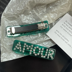 Deep green resin hair clip set with AMOUR rhinestone lettering and metal spring pin