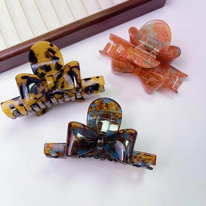 Three-piece set of butterfly acetate hair claws in tortoise shell and marble patterns