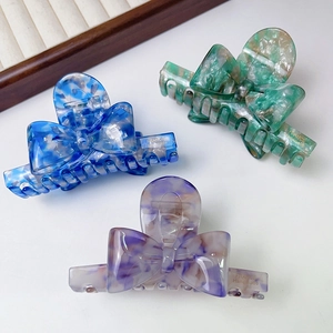 Chic acetate bow hair claws with floral patterns and gold handmade logo in three colors
