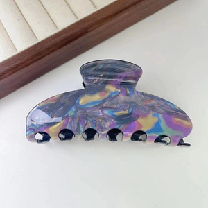 Macro detail of artistic acetate hair claw clip with colorful oil painting texture