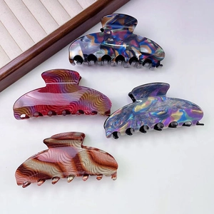 Elegant large hair claw clips in marble and wave patterns with high-gloss polished finish