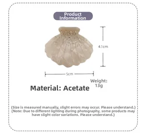 Detail view of shell-shaped acetate hair claw clip with rhinestones and 5cm size dimension