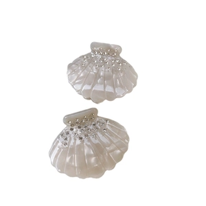 Pair of shell-shaped iridescent acetate hair clips with rhinestones for elegant styling