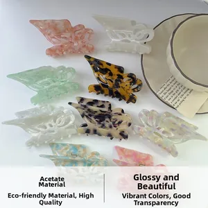 Various patterns of butterfly acetate hair claws displayed on a clean white background