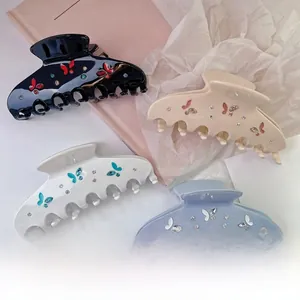 Detailed set of four acetate butterfly hair claws with rhinestones in elegant colors