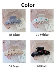 Set of four elegant acetate hair claws with butterfly patterns and small rhinestones