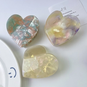 Elegant heart-shaped acetate hair claw clips with marble texture for women's hairstyling
