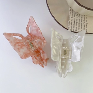 Elegant butterfly acetate hair claws with marble texture in pink and ivory white tones