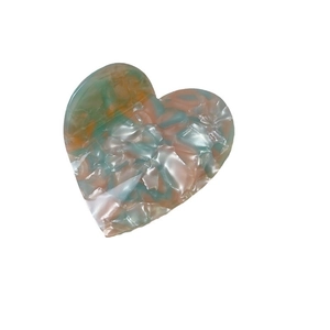 Checkered heart hair claw clip made of acetate with green and orange marble texture