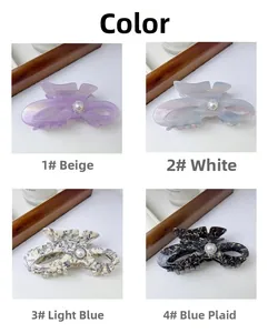 Close-up of acetic acid bow hair claws with faux pearl and rhinestone embellishments