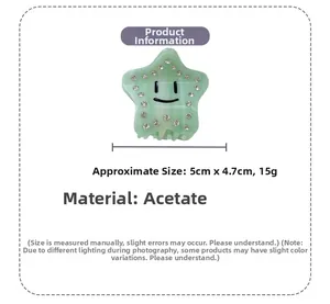Detail of light green acetate star hair claw clip with smiley face and rhinestones