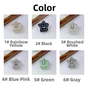 Detail view of colorful acetate star hair claws with smiley faces and rhinestone accents