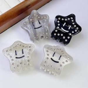 Pentagram acetate hair claws with smile patterns and rhinestones on white background