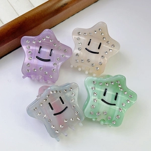 Acetate star hair claws set with smiley faces and rhinestones in pastel colors
