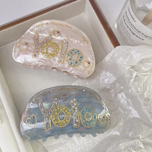 Luxurious Yolo letter acetate hair claw clips with colorful rhinestones and gold trim