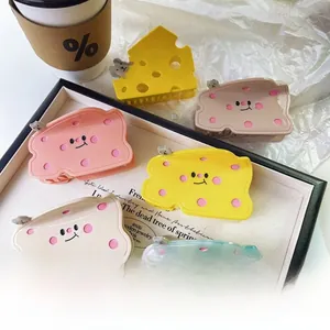Close-up of cute acetate hair clips featuring cheese and toast shapes in pastel tones
