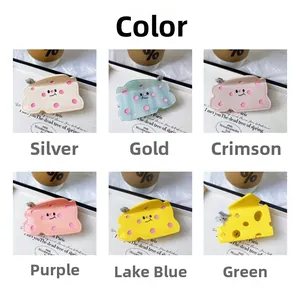 Detail view of 6 colorful cheese hair claws with cute cartoon mouse and face designs