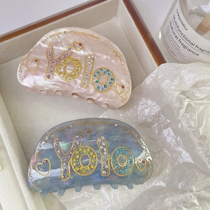 Luxurious handmade acetate hair claws with colorful rhinestones and YOLO lettering