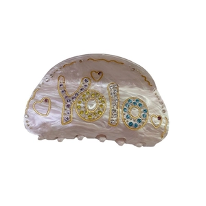 Pearly white acetate hair claw clip with colorful rhinestone YOLO letters and gold hearts