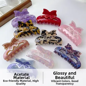 Various colorful acetate bow hair claw clips in elegant marble and leopard patterns