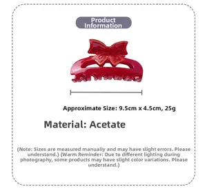 Detail view of red bow hair claw clip made of acetate with dimensions 9.5cm by 4.5cm