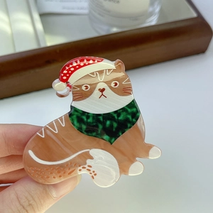Pince à cheveux chat de Noël en acétate avec chapeau rouge et écharpe verte festive