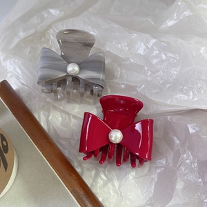 Elegant acetate bow hair claws with faux pearls in marble grey and magenta colors