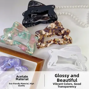 Detail showing various colors of cellulose acetate star hair claws with rhinestone accents