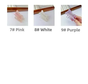 Detailed comparison of bear-shaped hair claws in pink, white, and purple with pearl accents