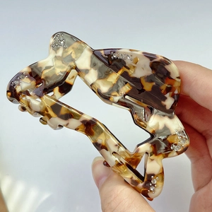 Macro shot of large tortoise shell acetate shark clip with sparkling rhinestones decoration