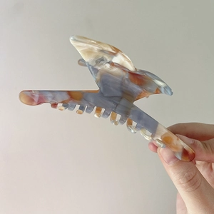Close-up of marble textured acetate butterfly hair claw clip with a secure sawtooth grip