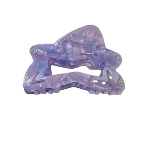 Elegant hollow star hair claw in purple marble acetate with sparkling rhinestones